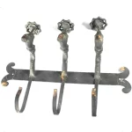 • Front view of the 15-3/4 inch by 10 inch Vintage Faucet Hook Wall Rack showing its rustic dull finish and antique metal patina.