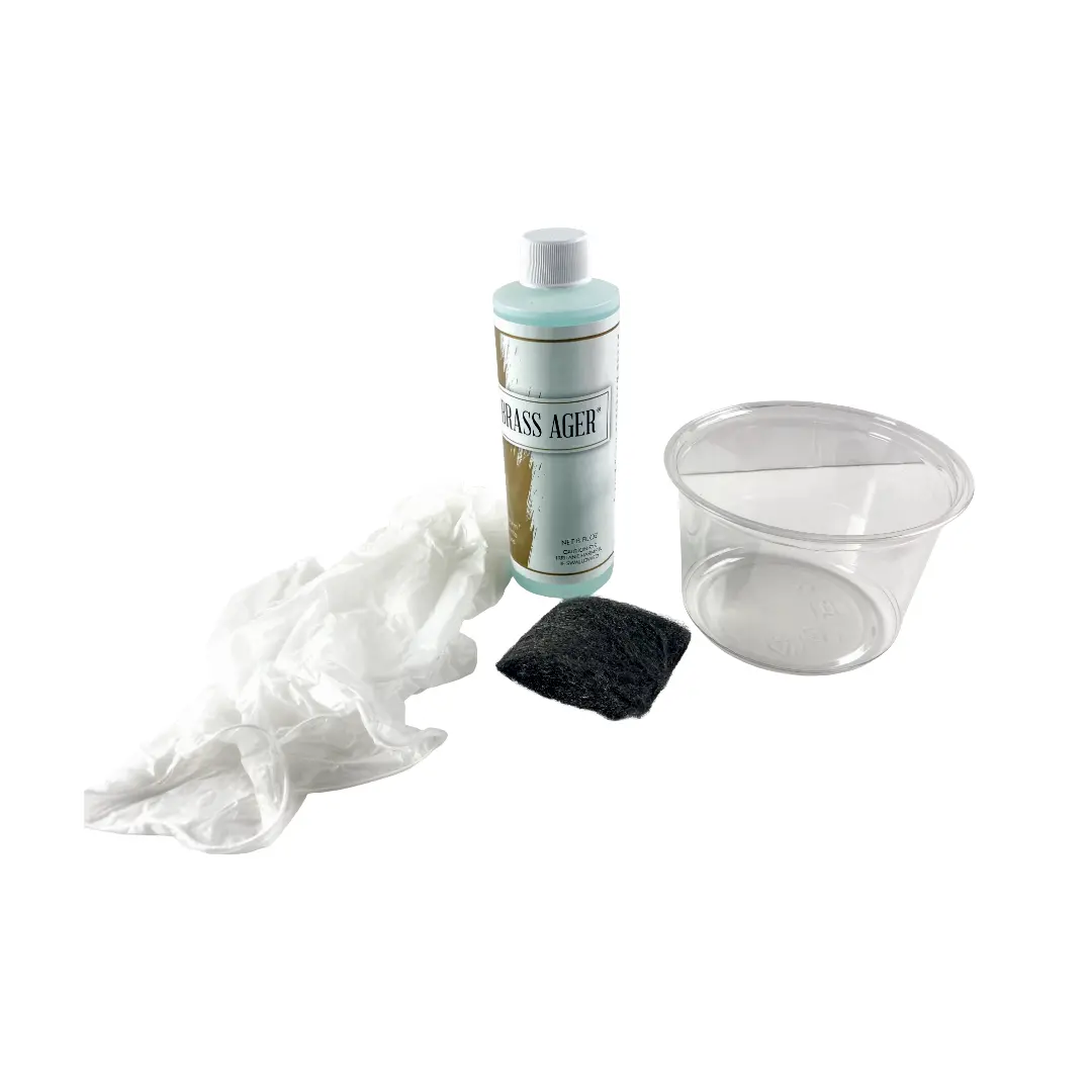 • Complete contents of the All-In-One Brassager Kit showcasing the 8oz bottle, dipping container, steel wool, and gloves on a clean surface.